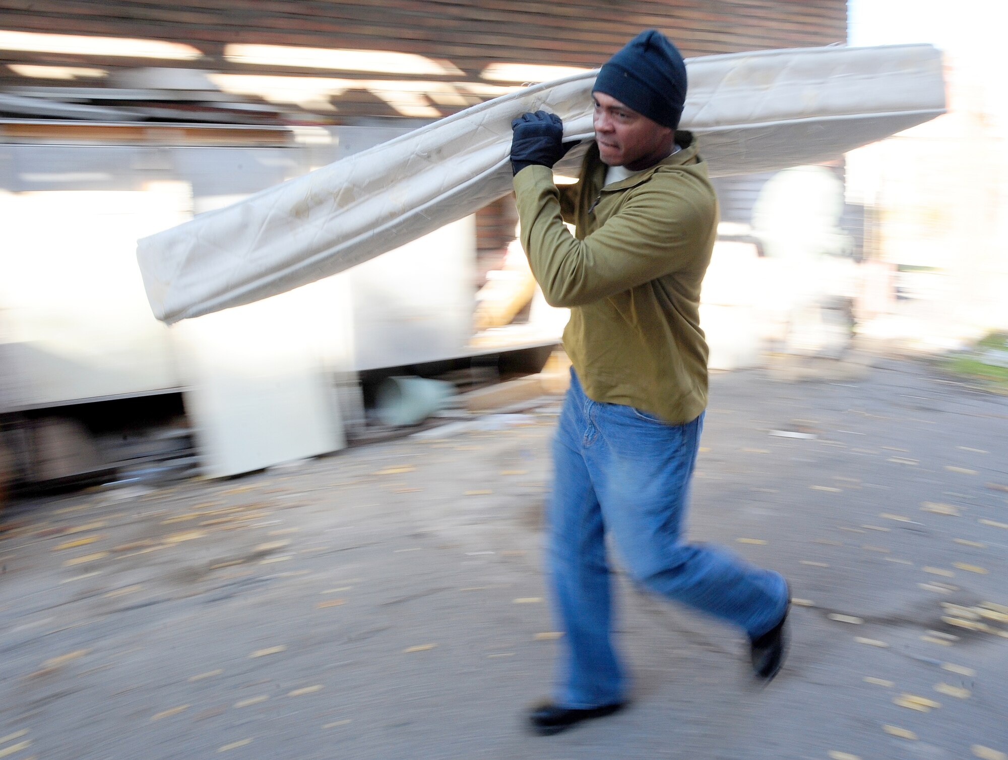 BISHKEK, Kyrgyzstan -- Master Sgt. Hubert Buchanan, 376th Expeditionary Aircraft Maintenance Squadron aerospace ground equipment flight chief, carries a mattress at the Bishkek Center for Mental Health. Airmen stationed at the Transit Center at Manas unloaded 300 mattresses and 240 bed frames, at the hospital, for donation. Sergeant Buchanan is deployed from the 20th Equipment Maintenance Squadron at Shaw Air Force Base, S.C. and hails from Bramwell, W.V. (U.S. Air Force photo/Senior Airman Steele C. G. Britton)