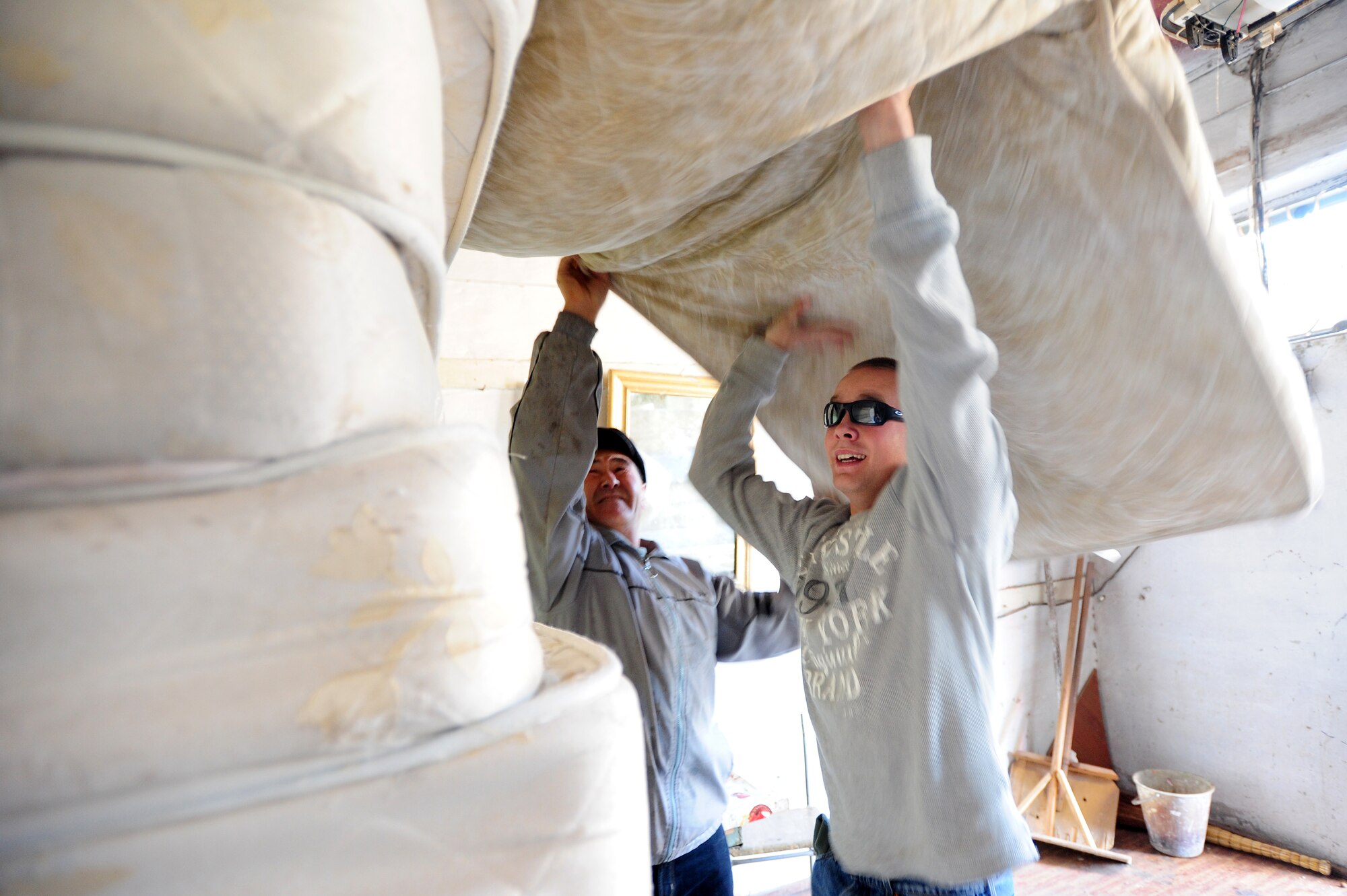 BISHKEK, Kyrgyzstan -- Airman 1st Class Kevin Kotrola, 376th Expeditionary Logistics Readiness Squadron vehicle maintenance technician, stacks mattresses at the Bishkek Center for Mental Health. Transit Center at Manas Airmen delivered 300 mattresses and 240 bed frames to the needy hospital. Airman Kotrola is deployed from 48th LRS at Royal Air Force Lakenheath, U.K. and is originally from San Antonio, Texas. (U.S. Air Force photo/Senior Airman Steele C. G. Britton)
