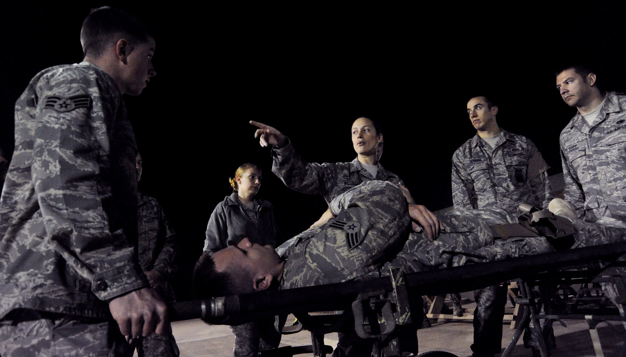 JOINT BASE BALAD, Iraq -- Staff Sgt. Tricia Williams, 332nd Expeditionary Medical Support Squadron patient administration and disposition boss, trains PAD volunteers in the procedures for transporting a patient at the Air Force Theater Hospital Nov. 4, 2009. The volunteer training consists of safety requirements, how to load and offload patients from helicopters, ambulances and mine resistant ambush protected vehicles and rules for moving within the emergency room. (U.S. Air Force photo/Senior Airman Christopher Hubenthal)