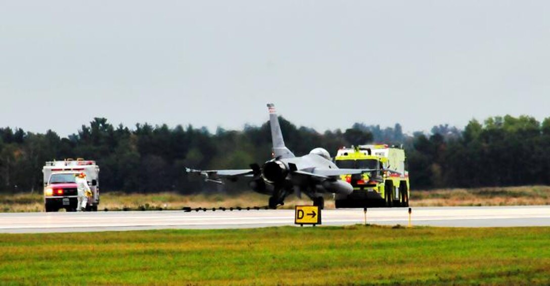 With a weight of 29,000 lbs. and at a speed of almost 110 MPH, Lt. Col. Nick Radney, a pilot with the115th Fighter Wing in Madison, Wis., brings an F-16 Fighting Falcon safely to a stop after a test of the Barrier Arresting Kit 12, a system designed to be "hooked" by an aircraft if needed to stop the aircraft.  Photo by Tech Sgt Kim Rodel, Volk Field CRTC.





