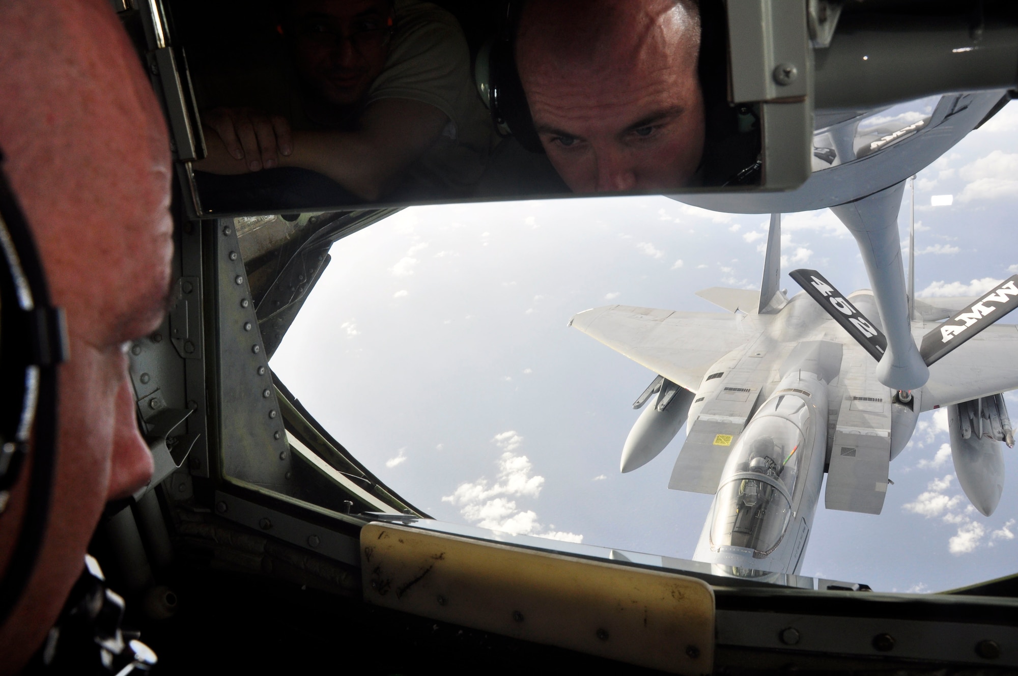 Tech. Sgt. Scot Parry, 48th Aerial Port Squadron, watches as Senior Master Sgt. Ray Lewis, a KC-135 Stratotanker boom operator from McConnell Air Force Base, Kan., refuels a Hawaii Air National Guard F-15 Eagle over the Hawaiian Islands Nov. 7 as a part of the 624th Regional Support Group’s first ever Employer Support Flight at Hickam Air Force Base, Hawaii. The event, held in co-operation with the Hawaii Committee of the Employer Support for the Guard and Reserve, helped employers better understand the time and sacrifice their employees invest in their role as Air Force Reservists. The KC-135 used for Saturday's Employer Support Flight is assigned to the 452nd Air Mobility Wing at March Air Reserve Base, Calif. (Air Force photo/Master Sgt. Daniel Nathaniel)
