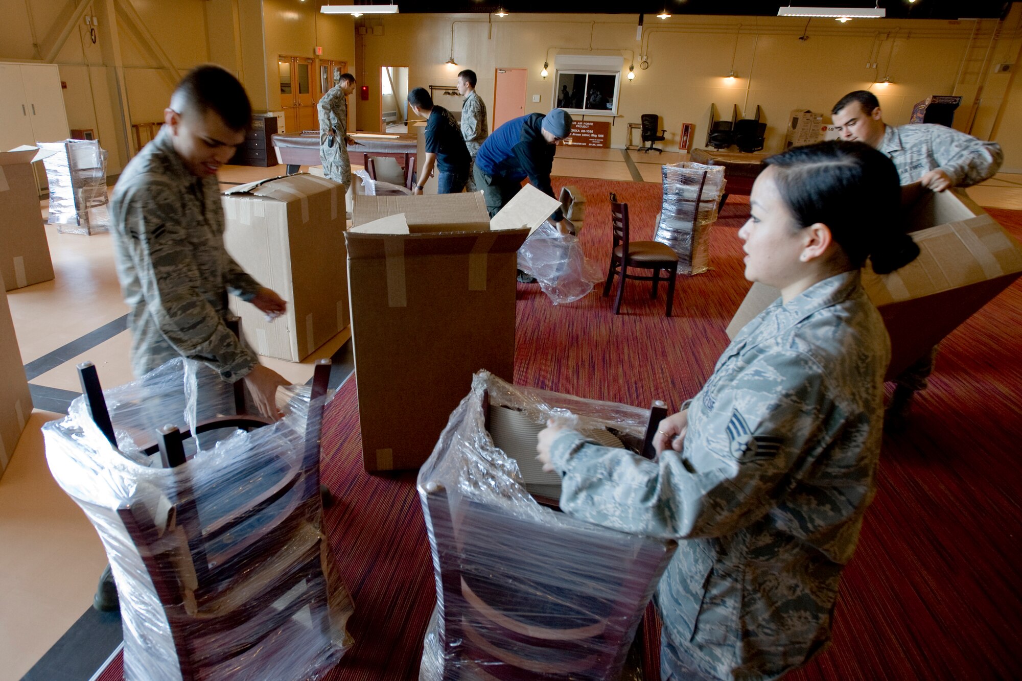 MISAWA AIR BASE, Japan -- Airman 1st Class Marcel Palomo and Senior Airman Alicia Savliejo, both 35th Force Support Squadron recreational specialists, help unpack furniture Nov. 6 at the Airman's Center. Development of the new Airman's Center began November 2008 and a grand opening is scheduled for Dec. 3. (U.S. Air Force photo/Senior Airman Jamal D. Sutter)