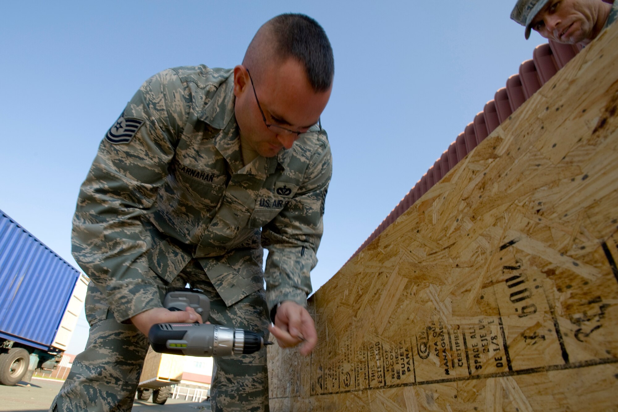 MISAWA AIR BASE, Japan -- Tech. Sgt. Thomas Carnahan, of the 35th Civil Engineer Squadron water and fuels maintenance flight, opens a cargo pallet Nov. 6 in preparation for the new Airman's Center grand opening. More than 15 volunteers from various squadrons came out to help upload the shipment. (U.S. Air Force photo/Senior Airman Jamal D. Sutter)
