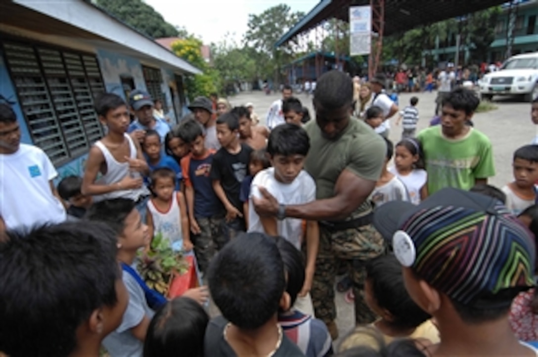 U.S. Navy Petty Officer 2nd Class Jonathan Porter, assigned to Joint Special Operations Task Force - Philippines, assists a dehydrated patient during a medical civil action project at John Spirig Sr. Memorial Elementary School in Zamboanga, Philippines, on Oct. 27, 2009.  Members of the task force are assisting Philippine airmen from the 3rd Civil Military Company with performing circumcisions, dental extractions and handing out free prescriptions for an expected patient load of over 1,000 individuals over a three-day period.  