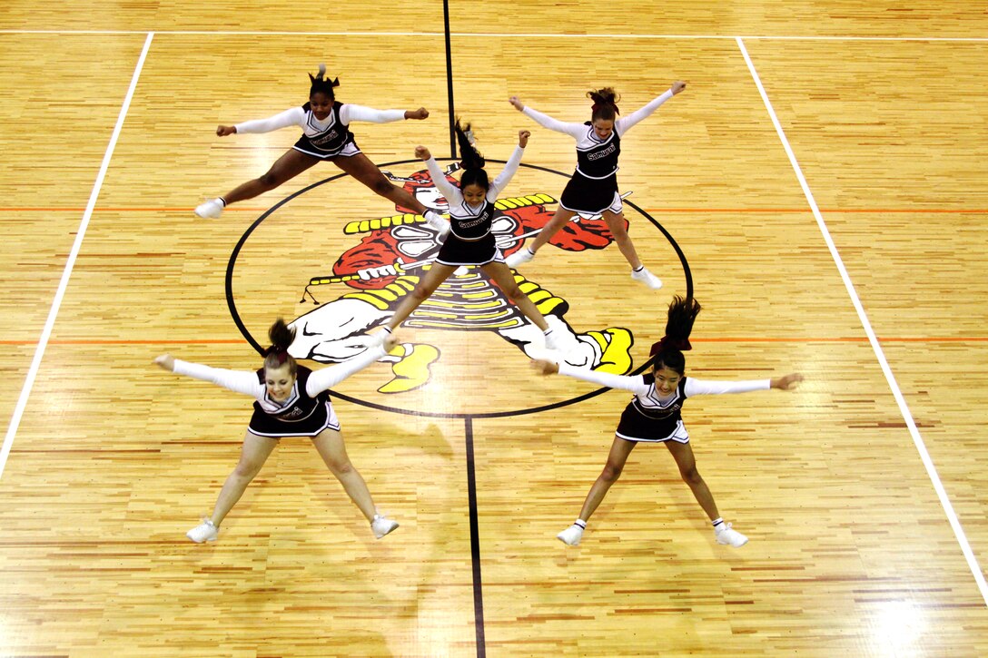 A cheer squad shows their stuff during the Top Gun competition at the Far East Cheerleading Clinic held at the Matthew C. Perry High School gymnasium here Nov. 9-13. Top Gun is a competition in which cheerleaders compete individually in four categories: tumbling, stunting, dance and jumps.