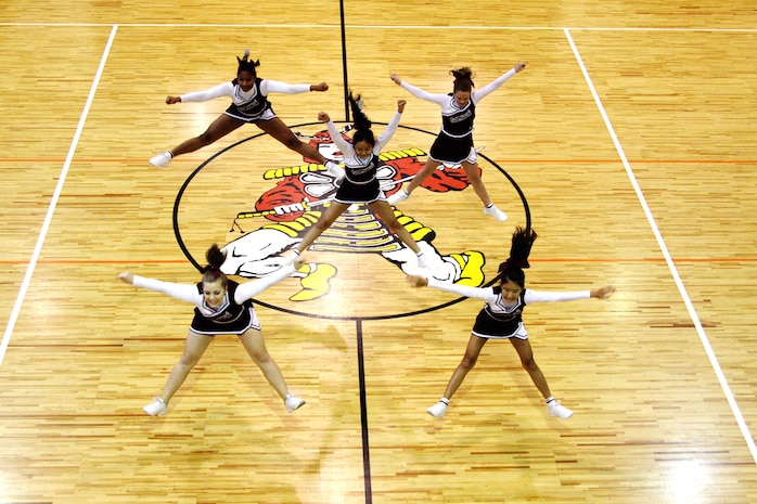 A cheer squad shows their stuff during the Top Gun competition at the Far East Cheerleading Clinic held at the Matthew C. Perry High School gymnasium here Nov. 9-13. Top Gun is a competition in which cheerleaders compete individually in four categories: tumbling, stunting, dance and jumps.