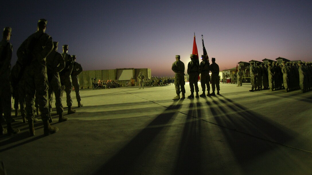 Combat Logistics Regiment 27 (Forward)’s color guard, flanked by two company formations, stand at the position of parade rest as they listen to a motivational speech given by Col. Vincent A. Coglianese, the commanding officer of CLR-27 (Fwd), during the Marine Corps birthday cake-cutting ceremony aboard Camp Al Taqaddum, Iraq, Nov. 10, 2009.  Following the ceremony the Marines gathered to enjoy refreshments and camaraderie that Marines are known for.  (U.S. Marine Corps photograph by Lance Cpl. Melissa A. Latty)