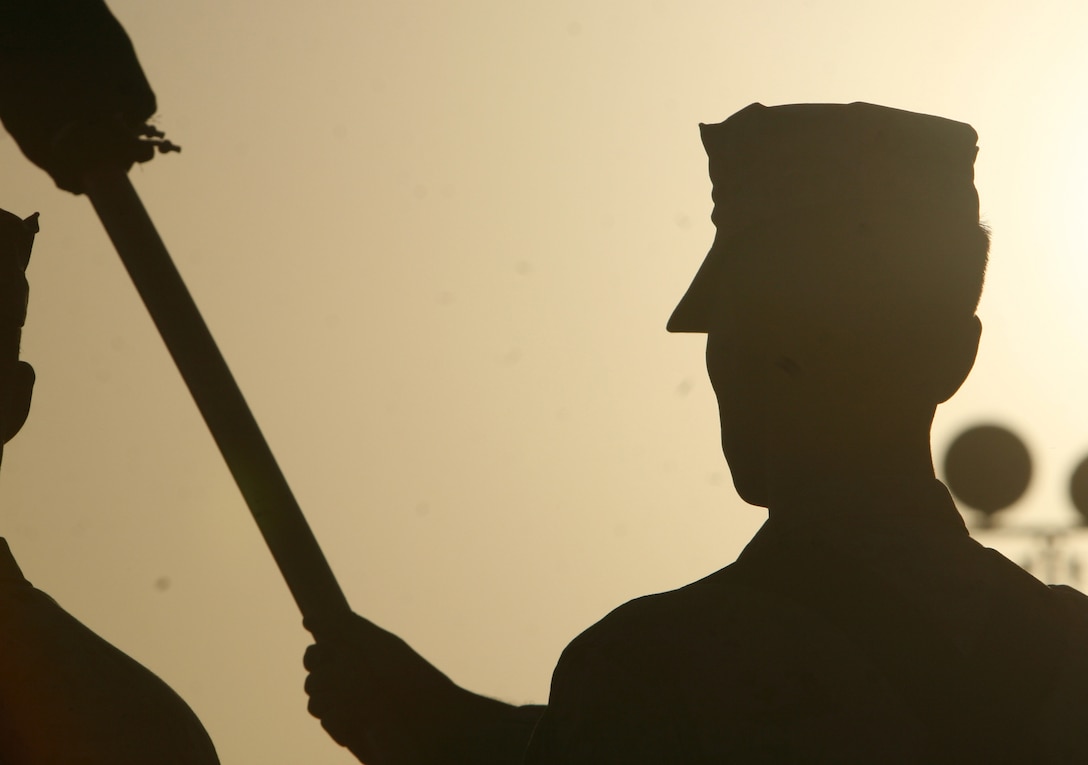 A Marine with Combat Logistics Regiment 27 (Forward) color guard, practices presenting the Marine Corps flag for the 234th Marine Corps birthday ceremony aboard Camp Al Taqaddum, Iraq, Nov. 10, 2009.  Following the ceremony the Marines gathered to enjoy refreshments and camaraderie that Marines are known for.  (U.S. Marine Corps photograph by Lance Cpl. Melissa A. Latty)
