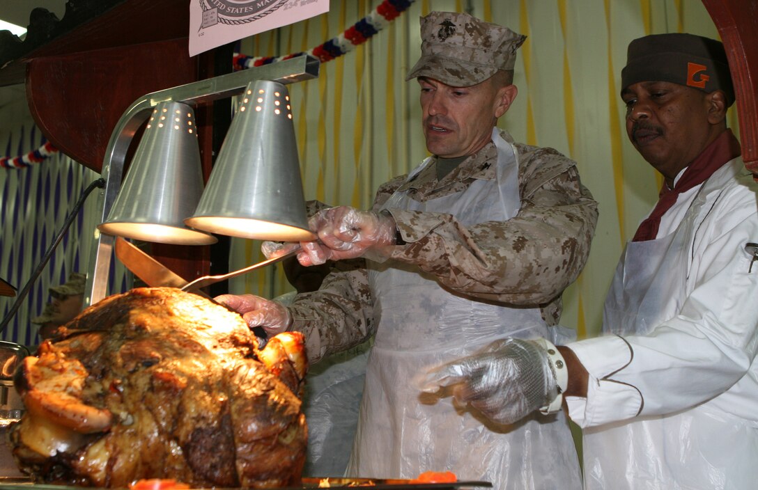 Col. Vincent A. Coglianese, the commanding officer of Combat Logistics Regiment 27 (Forward), carves a steamship round at the dining facility during a celebratory lunch in honor of the 234th Marine Corps birthday aboard Camp Al Taqaddum, Iraq, Nov. 10, 2009.  A cake-cutting ceremony was held later that night in front of a replica of the original Tun Tavern aboard the base.  (U.S. Marine Corps photograph by Gunnery Sgt. Katesha R. Washington)