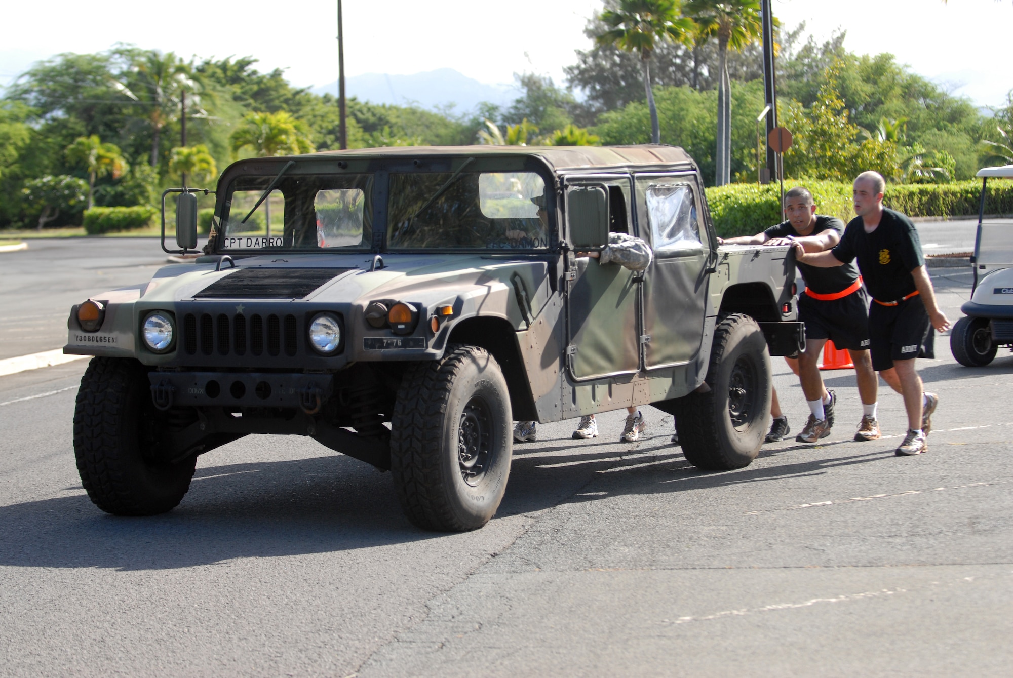HICKAM AIR FORCE BASE, Hawaii -- Members of the Schofield Barracks 7th Engineer Dive Team push a humvee as part of the Divers Challenge course here, Nov. 10. The event is held annually to challenge soldiers physically and mentally, build esprit de corps, and maintain traditions. (U.S. Air Force photo/Senior Airman Gustavo Gonzalez)