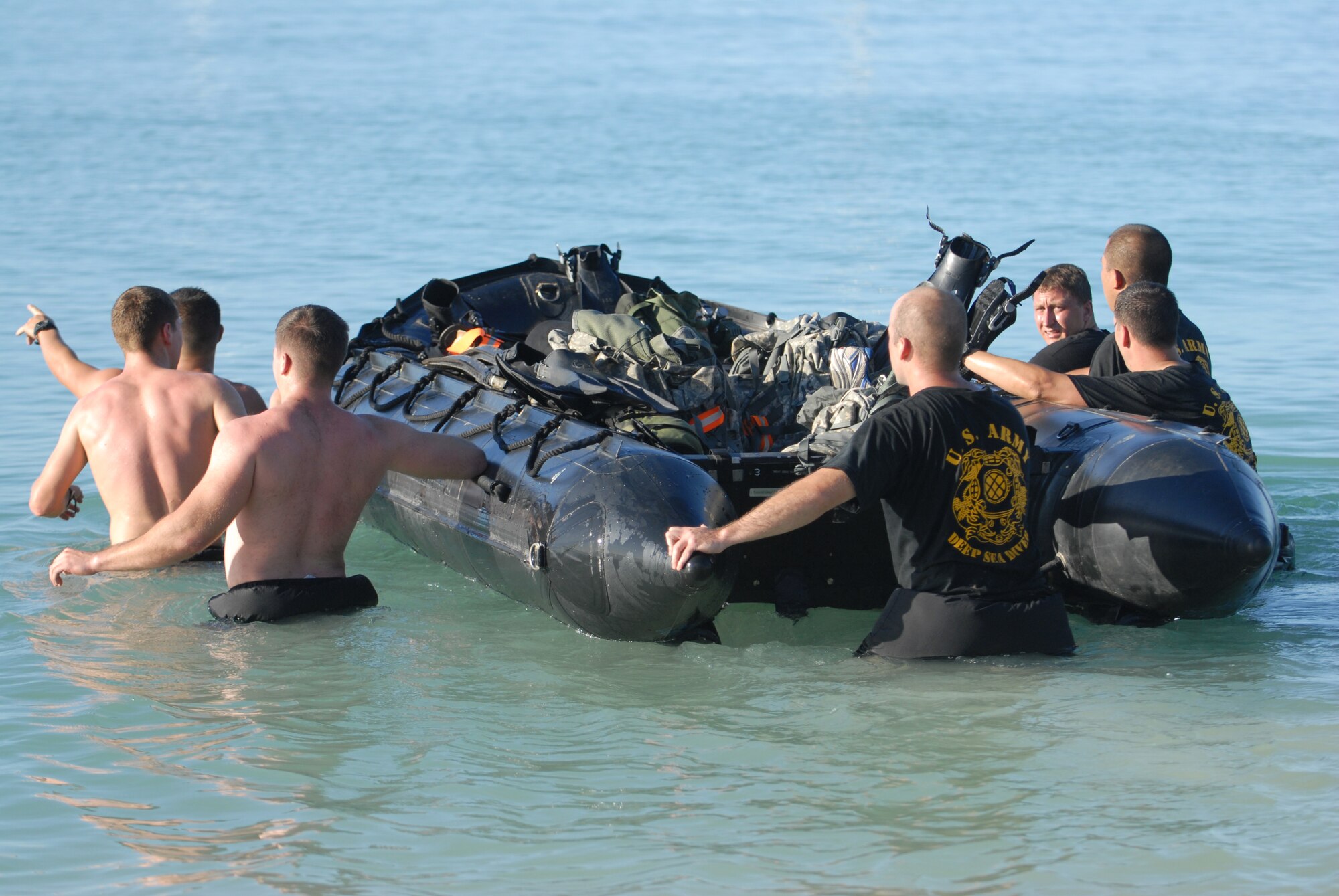 HICKAM AIR FORCE BASE, Hawaii -- Members of the Schofield Barracks 7th Engineer Dive Team enter the waters at Hickam beach as part of the Divers Challenge course here, Nov. 10. The event is held annually to challenge soldiers physically and mentally, build esprit de corps, and maintain traditions. (U.S. Air Force photo/Senior Airman Gustavo Gonzalez)