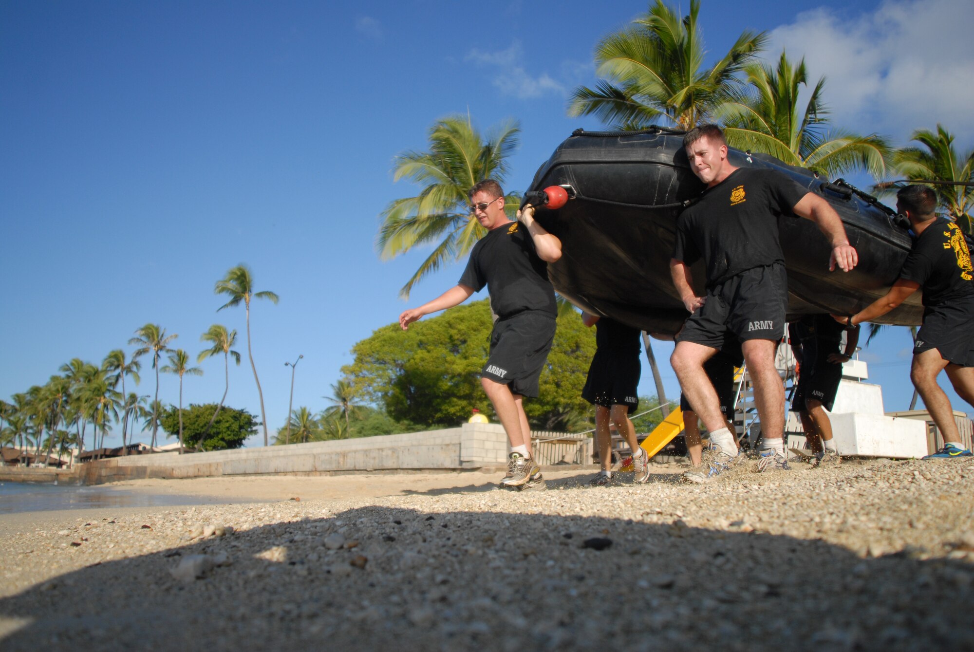 HICKAM AIR FORCE BASE, Hawaii -- Members of the Schofield Barracks 7th Engineer Dive Team carry a raft to Hickam beach before entering the water as part of the Divers Challenge course here, Nov. 10. The event is held annually to challenge soldiers physically and mentally, build esprit de corps, and maintain traditions. (U.S. Air Force photo/Senior Airman Gustavo Gonzalez)
