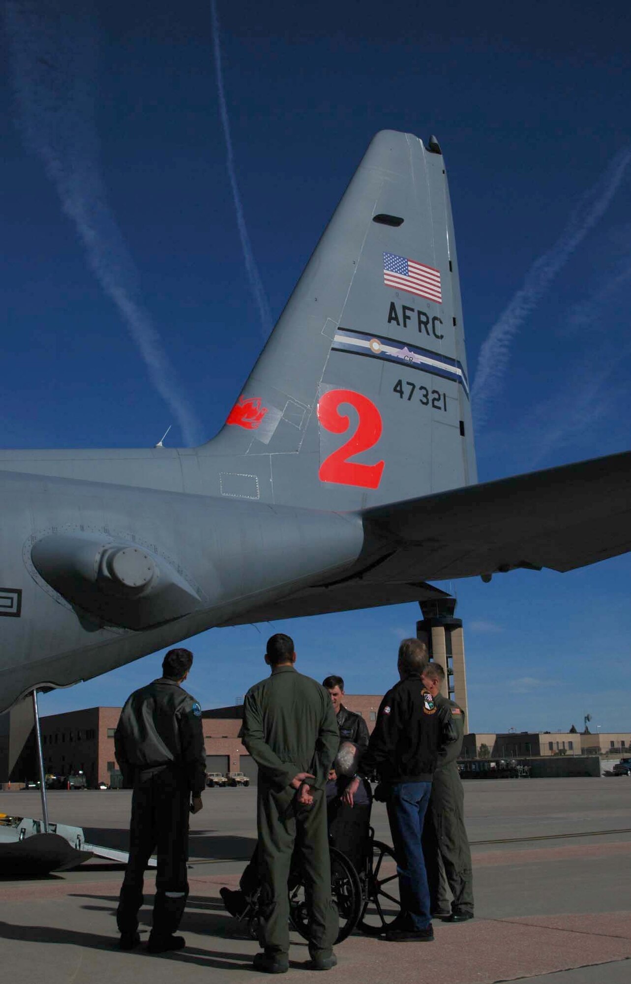 Air Force Col. (ret.) Mac Vickrey is surrounded by aircrew members of the Air Force Reserve Command's 302nd Airlift Wing Nov. 10 as he tours one of the unit's C-130 Hercules aircraft at Peterson Air Force Base, Colo. The 90-year-old Colonel Vickrey entered the U.S. Army in 1942, after being drafted in support of World War II. After joining, the colonel signed up for pilot training and served in the Army Air Force, then later the U.S. Air Force until 1973. During his career, he accumulated more than 15,000 flying hours on various aircraft, flew precious supplies to beleagured West Berliners during the 1948 Berlin Airlift, was tasked with running a Vietnamese base in support of the Vietnam War and flew the first airborne command and control aircraft for the Air Force: the EC-121. (U.S. Air Force photo/Staff Sgt. Stephen J. Collier)