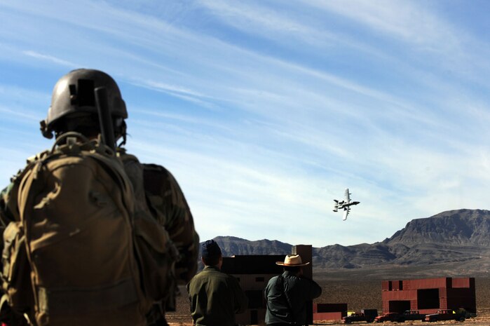 NEVADA TEST AND TRAINING RANGE-- Staff Sgt. James Spreter, a Combat Training Squadron joint terminal attack controller, leads an A10 Thunderbolt II to a target Thursday Nov. 5, 2009 at the Urban Operations Complex.  The UOC is a state-of-the-art urban facility providing the war fighter a full-spectrum urban combat training environment. (U.S. Air Force photo by Tech. Sgt. Michael R. Holzworth)