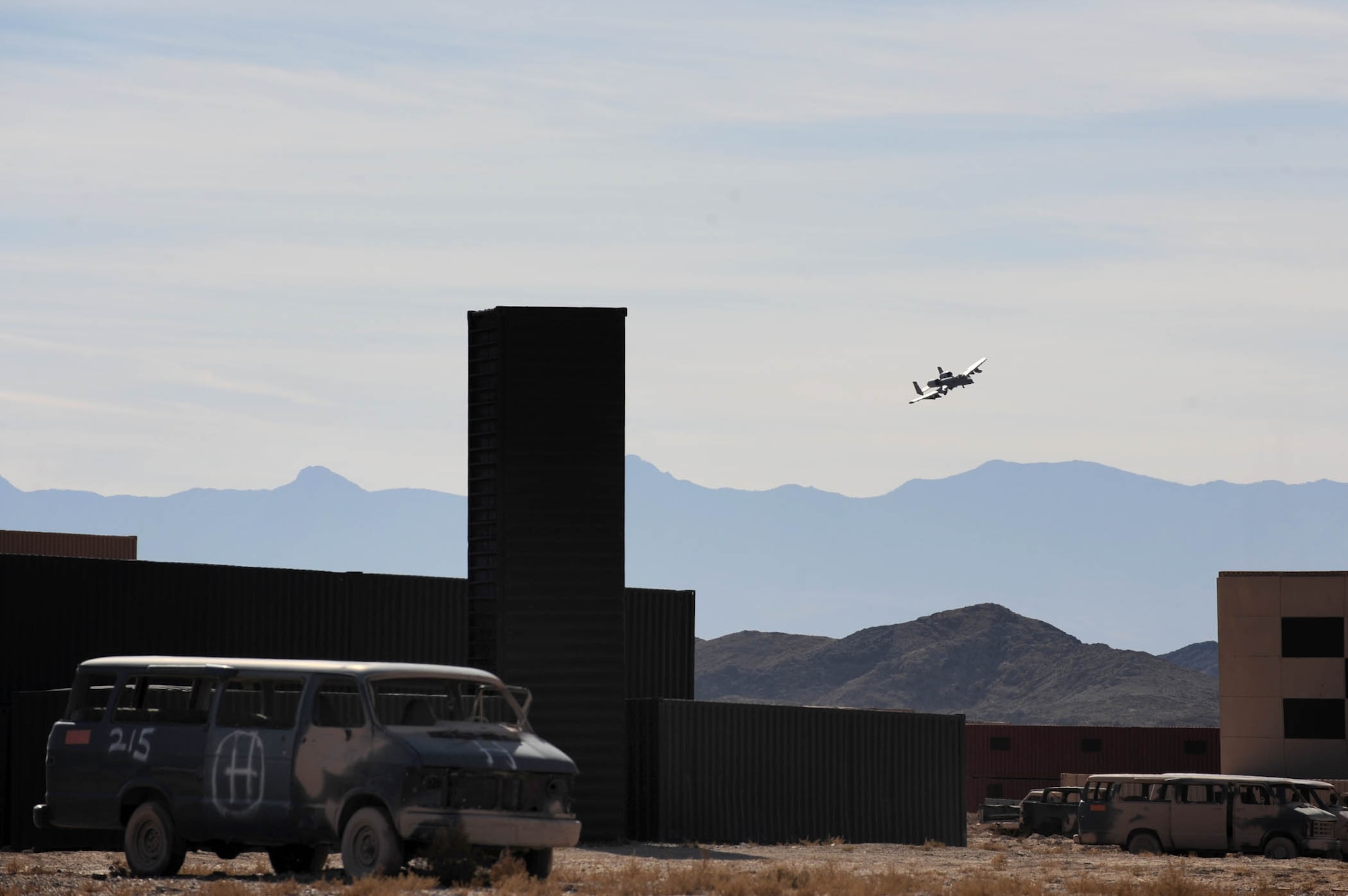 NEVADA TEST AND TRAINING RANGE-- An A10 Thunderbolt II flies over the Urban Operations Complex Thursday Nov. 5, 2009.  The UOC is a state-of-the-art facility on the NTTR providing the war fighter a full-spectrum urban combat training environment. (U.S. Air Force photo by Tech. Sgt. Michael R. Holzworth)