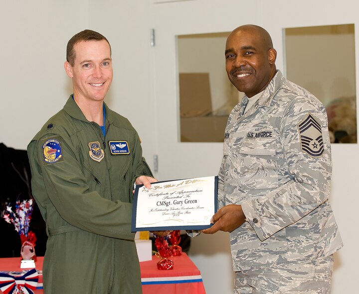 (Left to right) Lt. Col. Kevin Gordon, 3rd Airlift Squadron commander, presents a certificate of appreciation for commendable volunteer service to Chief Master Sgt. Gary Green, 512th Maintenance Squadron chief group manager Nov. 6. He was awarded the certificate for his volunteer coordination efforts for many Dover Air Force Base programs and fundraisers. (U.S. Air Force photo/Jason Minto)