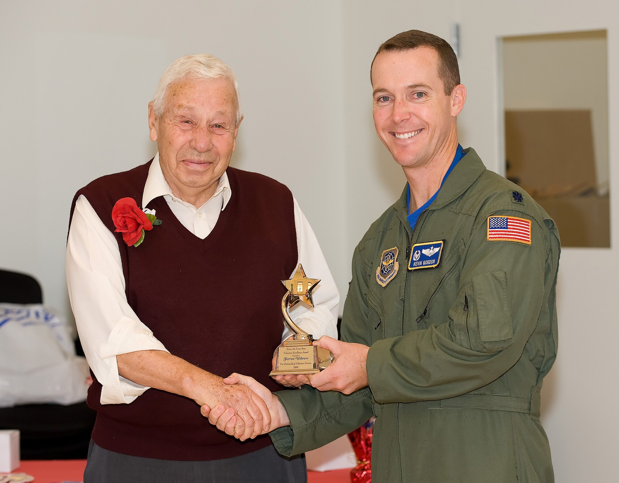 (Left to right) Forrest Withrow receives the Volunteer Excellence Award for Outstanding Service from Lt. Col. Kevin Gordon, 3rd Airlift Squadron commander, Nov. 6. Mr. Withrow has worked at the fitness center for more than 15 years. The Volunteer Excellence Award for Outstanding Service is a lifetime achievement award presented annually to an individual for excellence in providing volunteer services at Dover Air Force Base and placing service before self. (U.S. Air Force photo/Jason Minto)