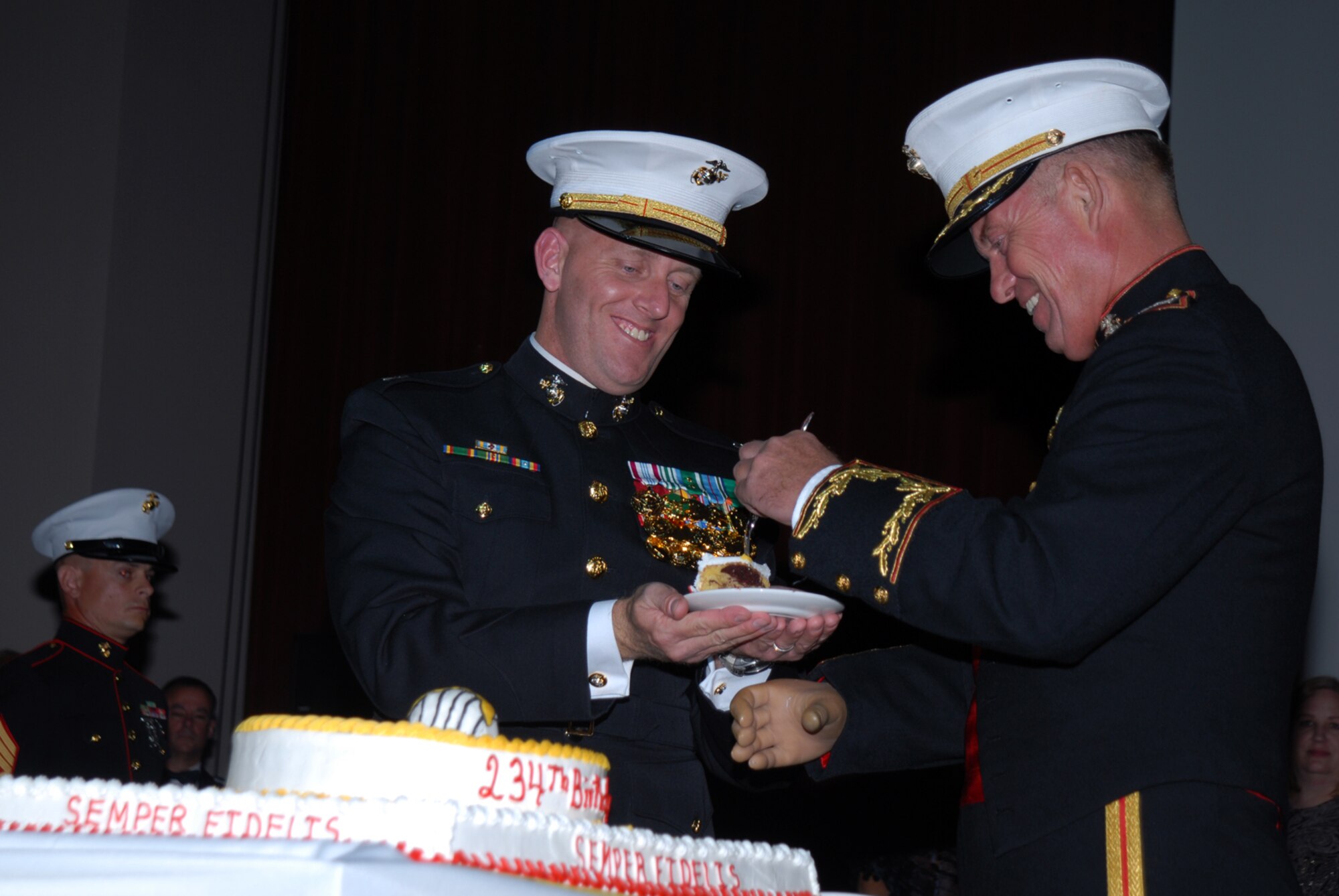 SAN ANGELO, Texas -- Retired Marine Col. Timothy Howard, Deputy Chief of Staff, Intelligence Marine Forces Pacific, receives the first piece of cake at the 234th Marine Corps Birthday Ball hosted by the Marine Corps Detachment, Goodfellow Air Force Base, Nov. 7, 2009. The first piece of cake is given to the guest of honor, the second to the oldest Marine present. Upon receiving the second piece of cake, the oldest Marine will in turn pass it on to the youngest Marine present, signifying the passing of experience and knowledge from the old to the young of the Corps. (U.S. Air Force photo/Staff Sgt. Laura R. McFarlane)
