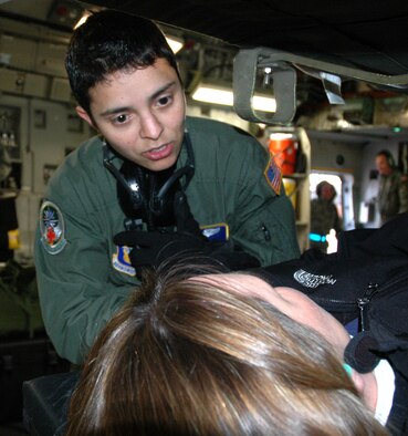 MCCHORD AIR FORCE BASE, Wash., - Staff Sgt. Juanita Elliott, a medical technician with the 446th Aeromedical Evacuation Squadron here, tends to her "patient," Ms. Susan VanTuinen, aboard a C-17 Globemaster III, during the 446th Airlift Wing's Employer Orientation Day here, Nov. 7. First Lt. Jen Miner, 446th Aeromedical Staging Squadron, is Ms. VanTuinen's employee at Sunwest-Checsteday Meadows Assisted Living. (US Air Force photo/Staff Sgt. Nicole Celestine)