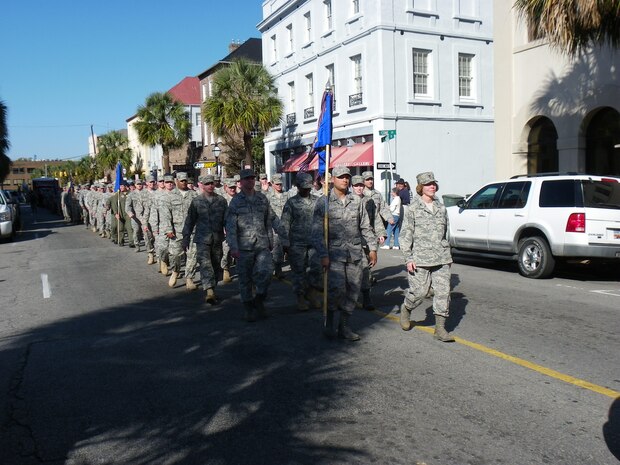 Col. Consuella Pockett and Senior Airman Claudio Collazo lead the 437th Medical Group formation as they march in the Charleston Annual Tri-County Veteran's Day Parade. This was the city's 12th year hosting the parade. Colonel Pockett is the 437 MDG commander and Airman Collazo is the NCOIC of Provider Services for the 437 MDG. (U.S. Air Force photo/Senior Master Sgt. Walter Bonner Jr.)
