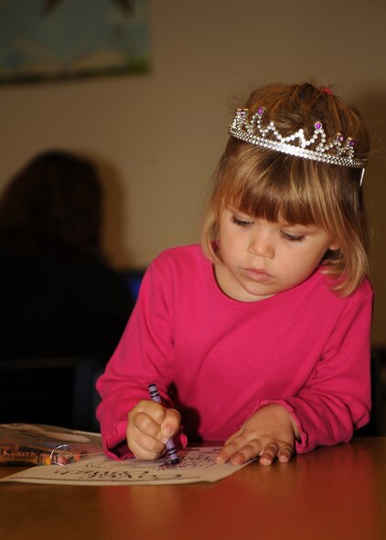 Rachel Schaub, age 3, colors a "Cover Your Cough" coloring sheet at the Watkins-Das Library on Seymour Johnson Air Force Base, N.C., Nov. 10, 2009. Rachel is the daughter of Tech. Sgt Maria Schaub from the Airmen and Family Readiness Center. (U.S. Air Force photo/Senior Airman Ciara Wymbs) 