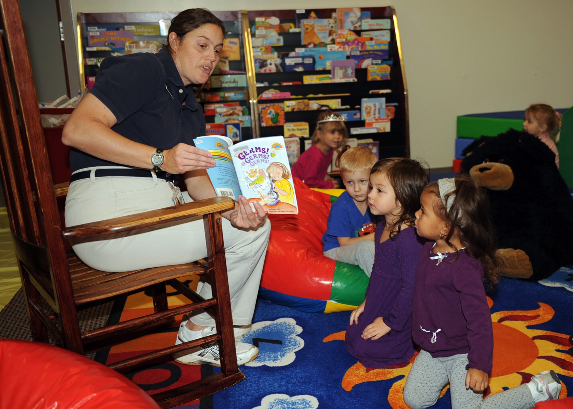 Arletta Thompson, Health and Wellness Center exercise physiologist, reads ?Germs, germs, germs? to base youth at the Watkins-Das Library on Seymour Johnson Air Force Base, N.C., Nov. 10, 2009.  The subject was chosen to raise awareness about the H1N1 virus and how to reduce the spread of germs. (U.S. Air Force photo/Senior Airman Ciara Wymbs) 