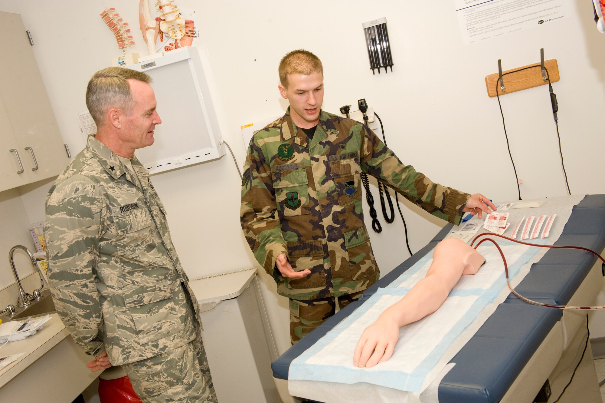 Senior Airman Craig Rockhold, 325th Medical Group Aerospace Medical Service technician, demonstrates how to administer an H1N1 flu shot to Brig. Gen. Darryl Roberson, 325th Fighter Wing commander, Nov. 10 here.  Airman Rockhold, selected for the Commander’s Shadow Program, delivers medical/preventive healthcare for the 325th Fighter Wing training mission.  He also enables wartime readiness and combat capability.  Serving in the Air Force for more than two years, Airman Rockhold hails from Seiling, Okala.  (U.S. Air Force photo/Jonathan Gibson)
