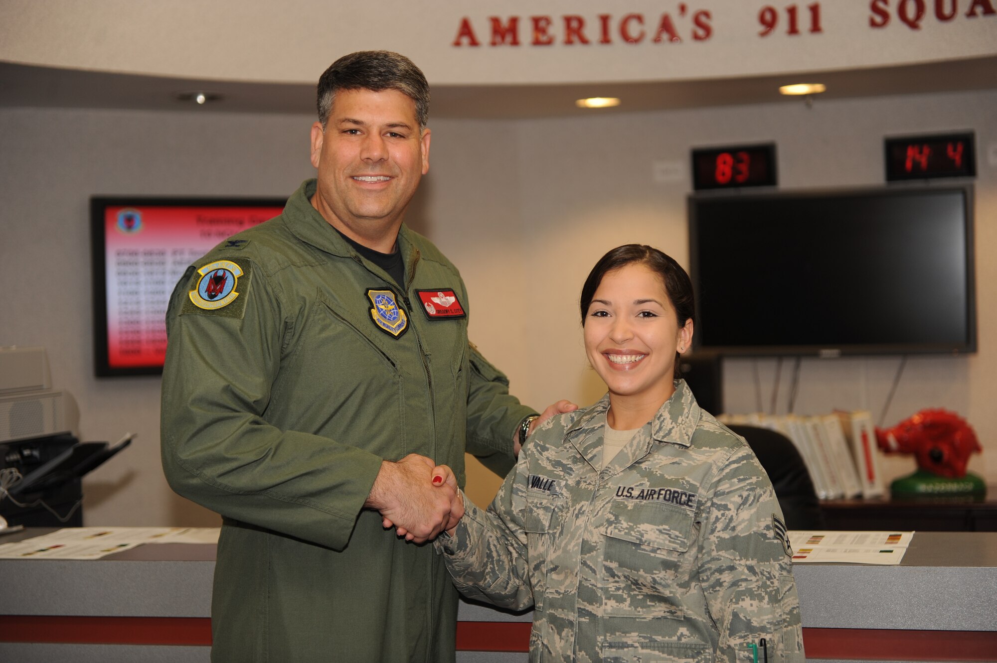 Col. Greg Otey, 19th Airlift Wing commander, presents a commander's coin to Senior Airman Del Valle, 50th Airlift Squadron aviation resource management system journeyman, for her selection as the Combat Airlifter of the Week. Airman Del Valle led her office through a 43 percent manning shortage, ensuring her section's mission success. As a trainer, she thoroughly trained more than 20 tasks to new Airmen in upgrade training, increasing her section's automated records management system proficiency by 40 percent. (U.S. Air Force photo by Staff Sgt. Chad Chisolm)