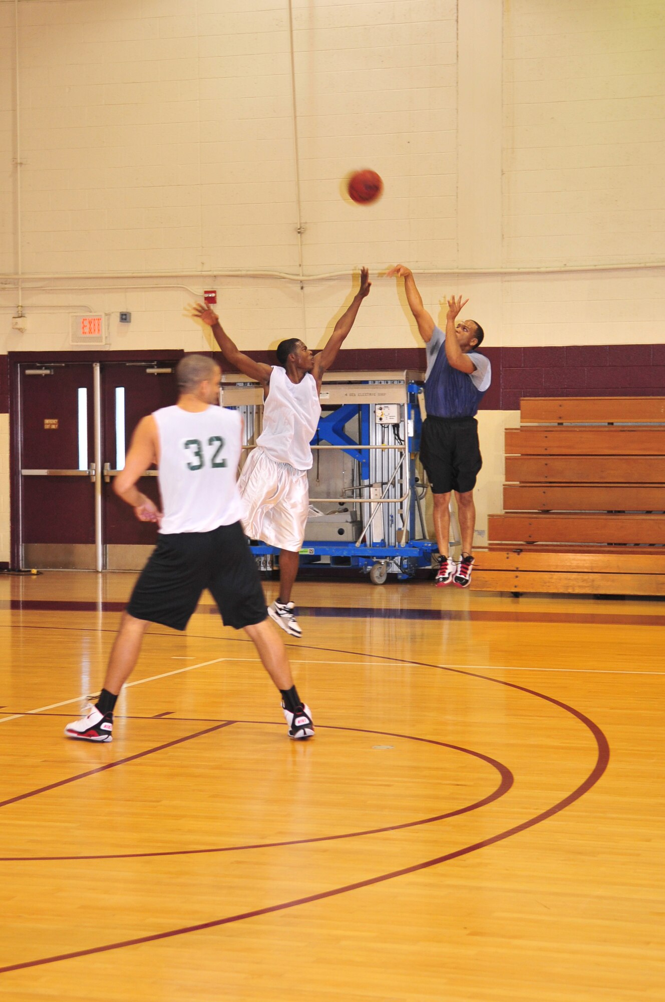 Sadarius Miley,  team Andrews guard, takes a shot from the three-point line while Roy Jackson, team Seymour Johnson forward, tries to block his shot during a varsity men's basketball scrimmage on Seymour Johnson Air Force Base, N.C., Nov. 7, 2009. The teams played two games with Seymour Johnson winning both. (U.S. Air Force photo/Airman 1st Class Rae Perry)