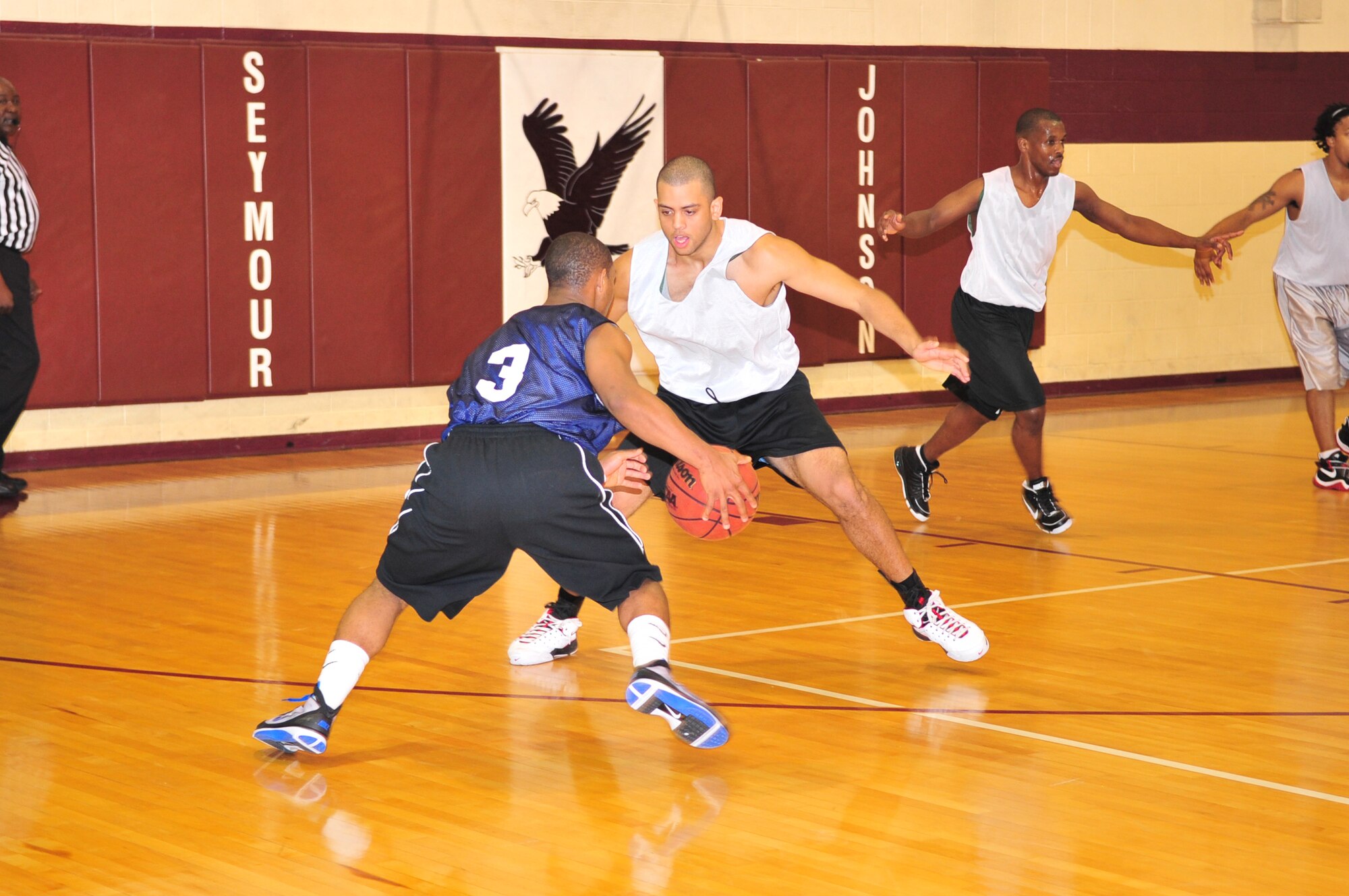 Timothy Stephens, team Seymour Johnson guard, blocks Vincent Jones, team Andrews guard, from passing the ball during a varsity men's basketball scrimmage on Seymour Johnson Air Force  Base, N.C., Nov. 7, 2009. A scrimmage is an informal match between two competitors which does not go on record. (U.S. Air Force photo/Airman 1st Class Rae Perry)
