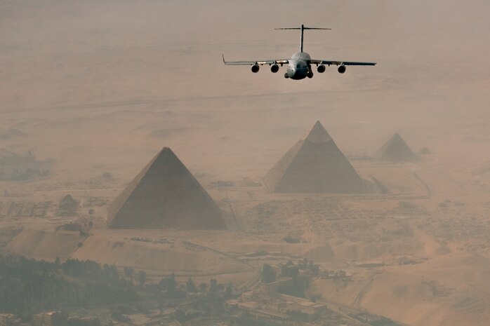 A C-17 flies over the Giza pyramids of Egypt while on approach for landing at Cairo East Airport. The aircraft was participating in the Bright Star Exercise in Egypt Oct. 15. (U.S. Air Force photo/Col. Joseph Mancy)