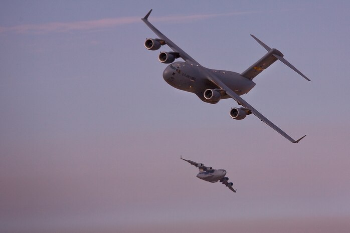 Two Charleston-based C-17s flying in formation perform a shackle maneuver while participating in the Bright Star Exercise in Egypt Oct. 15. (U.S. Air Force photo/Col. Joseph Mancy)