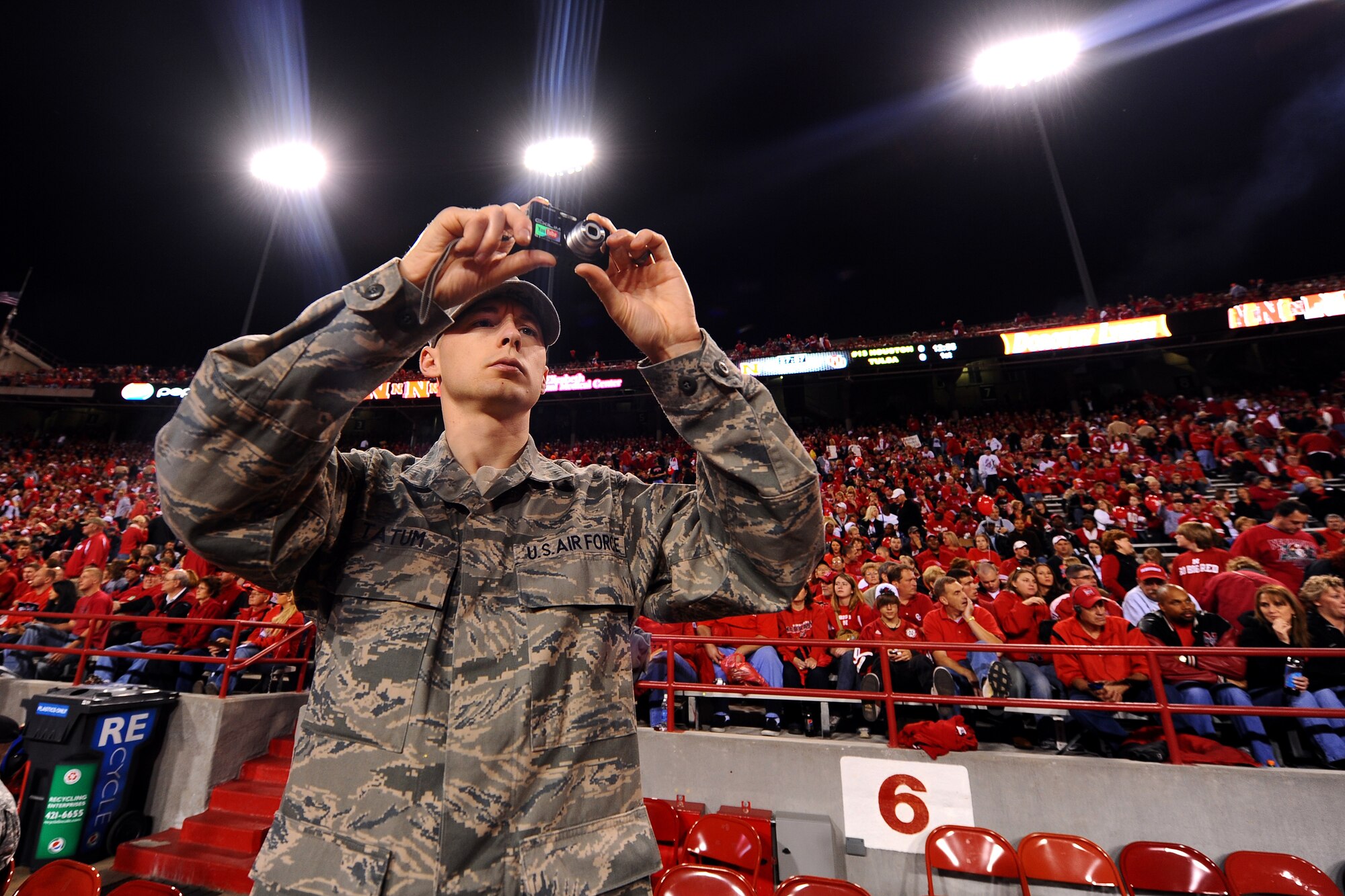 OFFUTT AIR FORCE BASE, Neb. - Staff Sgt. Mathew Tatum, a chaplain assistant with the 55th Wing Chapel, takes photos from the University of Nebraska sideline during the military appreciation football game against Oklahoma in Lincoln's Memorial Stadium, Nov. 7.  The University of Nebraska set aside several rows of seats for members of the military duirng the game, including members of Team Offutt.

U.S. Air Force photo by Josh Plueger
