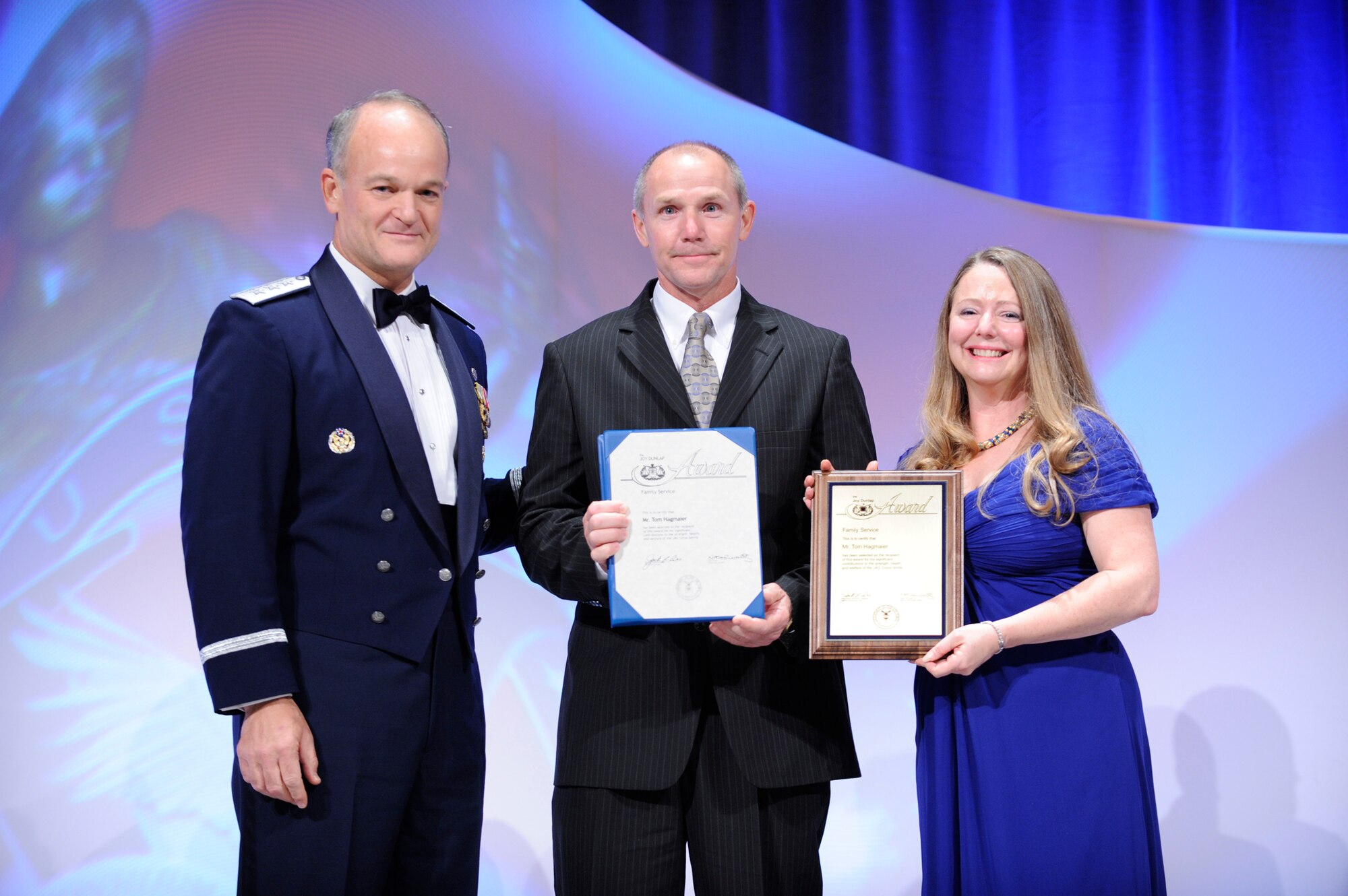 Lt. Gen. Jack L. Rives presents the Joy Dunlap Family Service Award to Tom Hagmaier as Ms. Dunlap assists.  The presentation took place during the U.S. Air Force Judge Advocate General Corps' Keystone Conference 2009 Oct. 29, 2009, in Dallas. (U.S. Air Force photo/Jim Varhegyi)