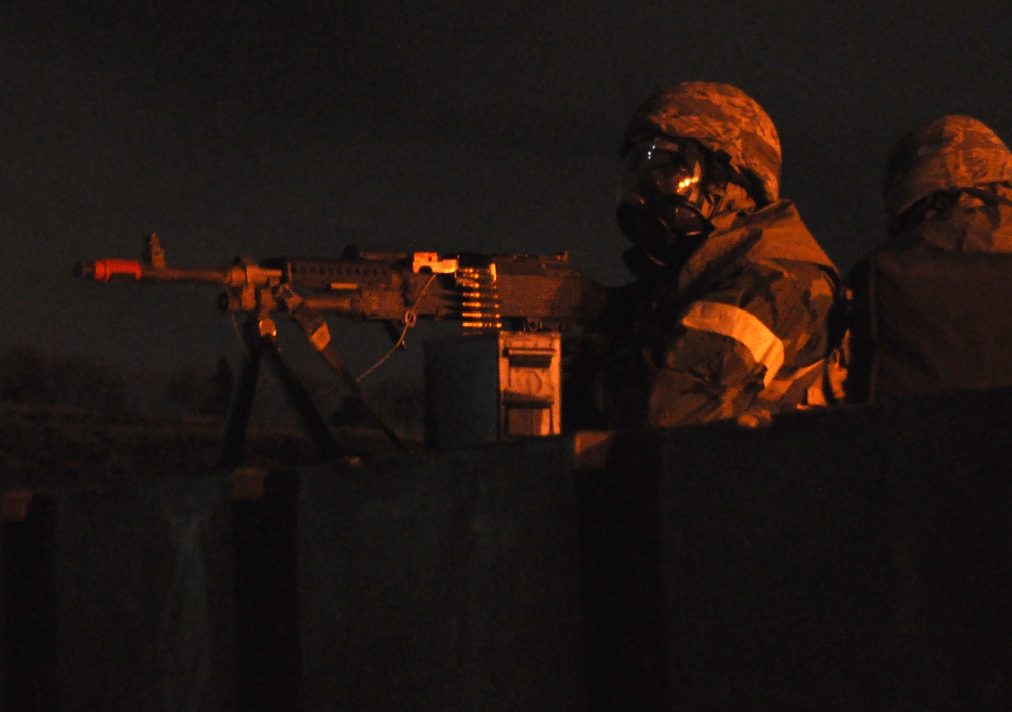 Airmen from the 419th Security Forces Squadron man an M-240 machine gun in full chem gear during night operations for the November ORE. (U.S. Air Force photo/Staff Sgt. Kyle Brasier)