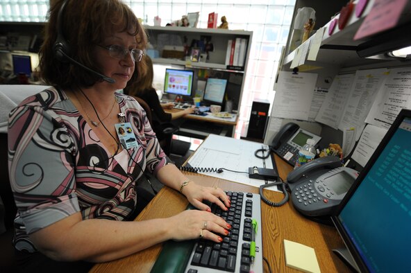 MINOT AIR FORCE BASE, N.D. -- Sarah Gartner, 5th Medical Group, TRICARE and Patient Administration operator, schedules a medical appointment for a patient Nov. 9. The 5th MDG was inspected in 16 areas covering four major categories and received an overall rating of excellent. (U.S. Air Force photo by Staff Sergeant Stacy Moless)
