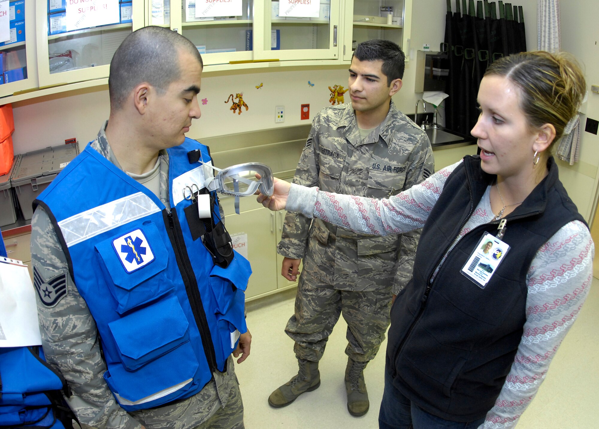 MINOT AIR FORCE BASE, N.D. -- Callie Augustson, 5th Medical Support Squadron medical readiness planner and analyst, shows Staff Sgt. Jesus Olivares, 5th Medical Support Squadron medical readiness noncommissioned officer-in-charge, and Senior Airman Eric Estrada, 5th MDSS medical readiness technician, the key facets of a quick response vest during a training exercise to ensure they are ready to ensure Minot Airmen are safe Nov. 5 here. The medical readiness flight ensures 5th Medical Group Airmen are ready to deploy in support of their countries interests around the world. The 5th MDG recently underwent a Health Services Inspection that covered 16 areas in four major categories. The group received an overall rating of excellent with eight of the graded areas receiving an outstanding, the highest rating possible. (U.S. Air Force photo by Airman 1st Class Benjamin Stratton)