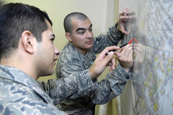 MINOT AIR FORCE BASE, N.D. -- Staff Sgt. Jesus Olivares, 5th Medical Support Squadron medical readiness noncommissioned officer-in-charge, trains Senior Airman Eric Estrada, 5th MDSS medical readiness technician, on how to properly route an ambulance to an incident on base in the event of a medical emergency Nov. 5 here. The medical readiness flight ensures 5th Medical Group Airmen are ready to deploy in support of their countries interests around the world. The 5th MDG recently underwent a Health Services Inspection that covered 16 areas in four major categories. The group received an overall rating of excellent with eight of the graded areas receiving an outstanding, the highest rating possible. (U.S. Air Force photo by Airman 1st Class Benjamin Stratton)