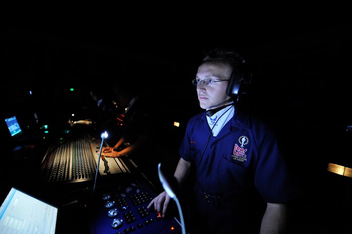 Senior Airman Blake Whilden adjusts lights during the Tops in Blue "To Dream" show at the North Charleston Performing Arts Center  in North Charleston Nov. 8. Tops in Blue is a self-contained operational unit with each member being assigned logistical responsibilities such as ground transportation, airlift, lodging, dining, wardrobe and palletizing throughout the tour. Airman Whilden is the lighting director with Tops in Blue. (U.S. Air Force photo/James Bowman)