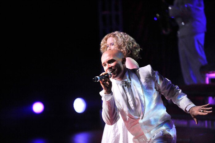 Senior Airman Jeffery Collins sings in the Tops in Blue "To Dream" show at the North Charleston Performing Arts Center in North Charleston Nov. 8. Tops in Blue performers not only must master the instrumental, vocal, choreography and staging requirements of the performance, but also the responsibilities of being their own technical staff. Airman Collins is a vocalist with Tops in Blue. (U.S. Air Force photo/James Bowman)