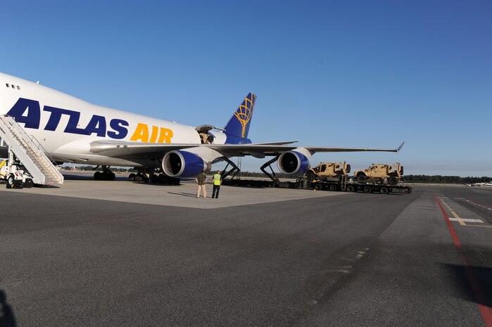 New mine-resistant, ambush-protected all-terrain vehicles sit on the flightline as they are prepared to be loaded onto a Boeing 747-400 aircraft here Nov. 7. Charleston AFB serves as the primary aerial port for M-ATV shipments to Afghanistan. (U.S. Air Force photo/Staff Sgt. Marie Brown)