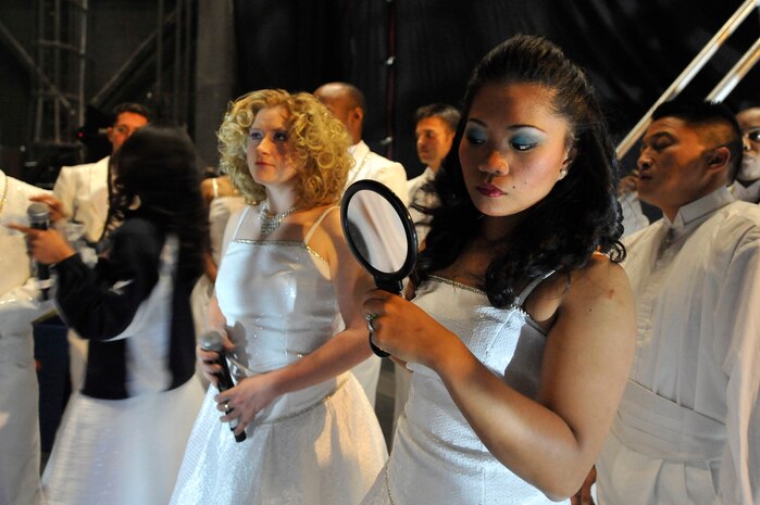Senior Airman Cristy Henderson looks at her make-up in the mirror  prior to the Tops in Blue "To Dream" show at the North Charleston Performing Arts Center in North Charleston Nov. 8. The mission of Tops and Blue is to perform for military members and their families throughout the world. Airman Henderson is a vocalist with Tops in Blue. (U.S. Air Force photo/James Bowman)