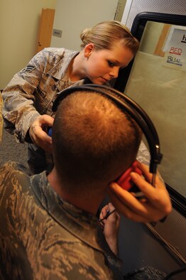 MINOT AIR FORCE BASE, N.D. -- Senior Airman Samantha Estrada, 5th Medical Operations Squadron public health technician, assists a patient prior to a hearing test here Nov 4. The 5th Medical Group is meeting the challenge of safe effective delivery of healthcare coupled with significant deployment and heavy readiness exercise obligations.  The medical group was rated outstanding in eight of the 16 topical graded areas during the Air Force Inspection Agency Health Services Inspection and captured an overall excellent rating. (U.S. Air Force photo by Tech. Sgt. Lee A. Osberry Jr.)