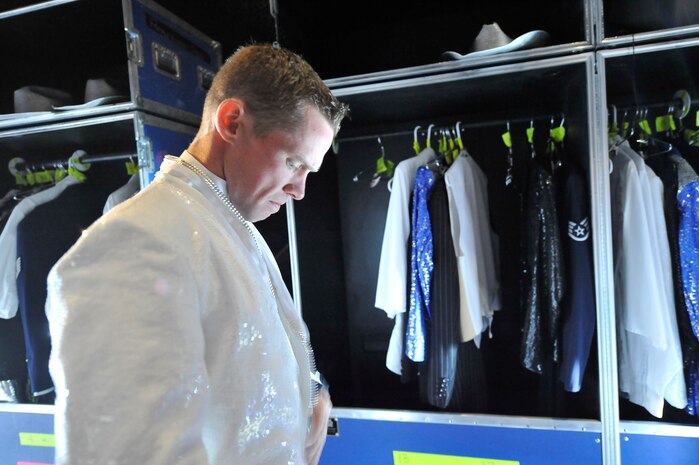 Staff Sgt. Timothy Womble prepares his outfit prior to the Tops in Blue "To Dream" show at the North Charleston Performing Arts Center in North Charleston Nov. 8. Tops in Blue is a complete self-contained operational unit and each member is assigned logistical responsibilities such as ground transportation, airlift, lodging, dining, wardrobe and palletizing throughout the tour. Sergeant Womble is a vocalist with Tops in Blue. (U.S. Air Force photo/James Bowman)
