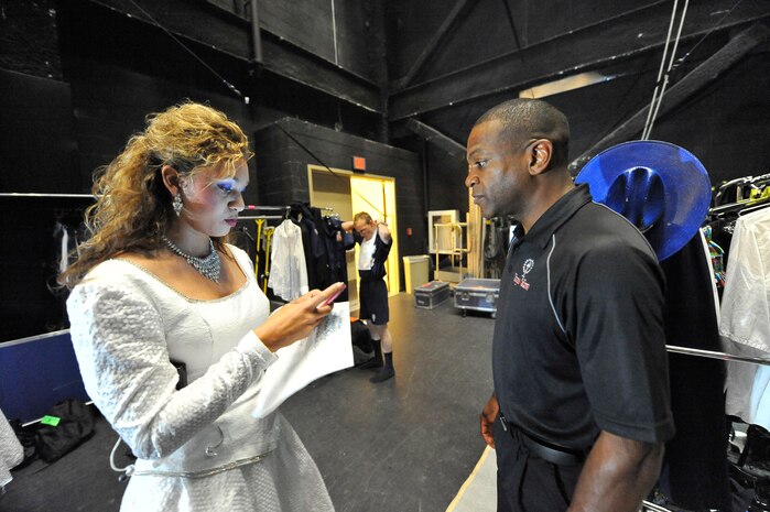 First Lt. Angela Waterworth and Master Sgt. James Green coordinate Tops in Blue issues at the North Charleston Performing Arts Center in North Charleston Nov. 8. Known as the Air Force's expeditionary entertainment group, Tops in Blue travels to perform at deployed locations where service members are stationed. Lieutenant Waterworth is a keyboard player and the officer in charge with Tops in Blue, and Sergeant Green is the chief of operations with Tops in Blue. (U.S. Air Force photo/James Bowman)
