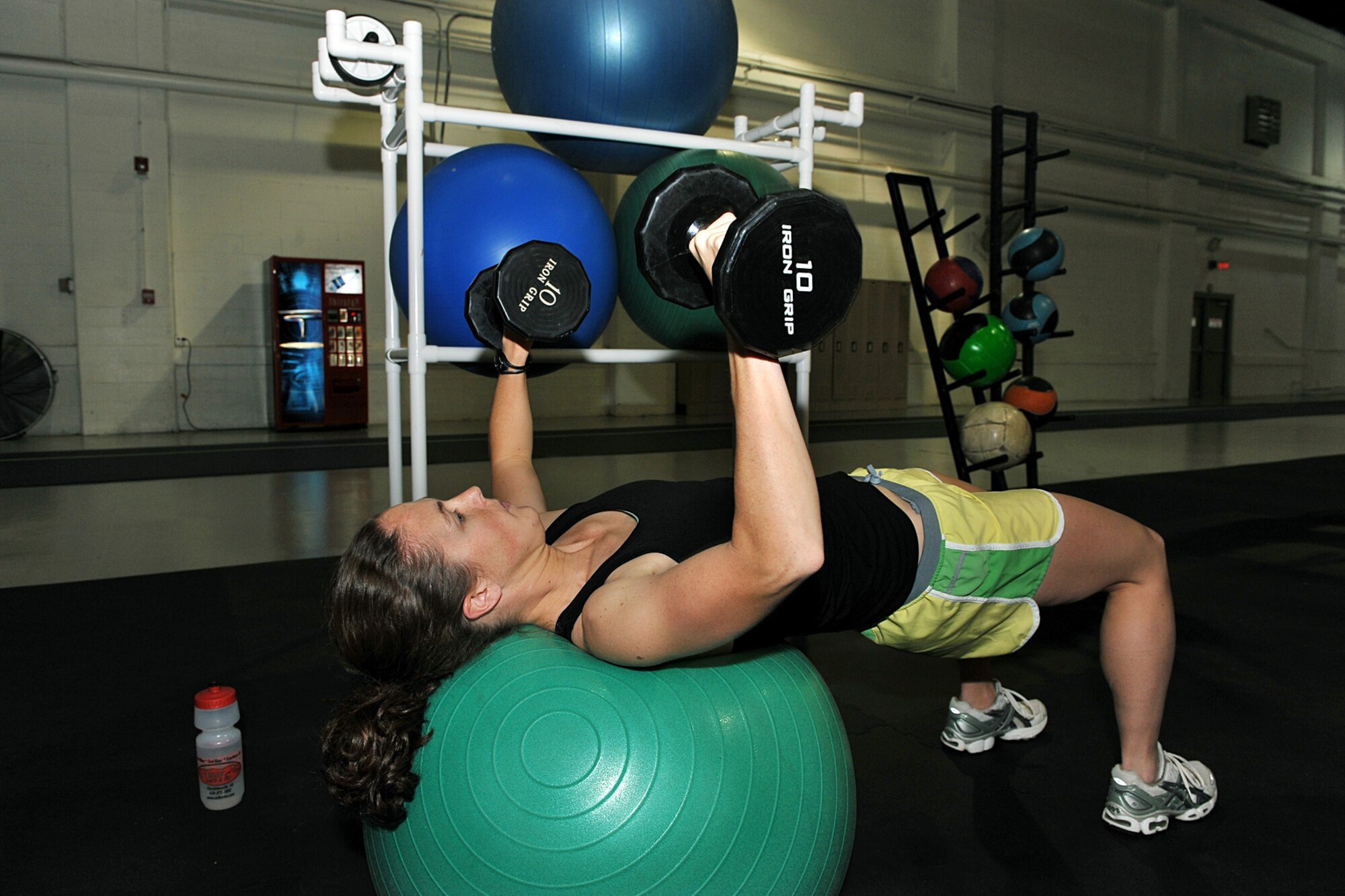 OFFUTT AIR FORCE BASE, Neb. -- Second Lt. Lindsey Myhr, 55th Maintenance Squadron accessory flight commander, uses dumb bells inside the Offutt Field House here Nov. 5 in preparation for her next triathlon. A basic triathlon event consists of a 1.5-km swim, a 40-km bike ride, and a 10-km run. The biggest triathlon event, the Iron Man challenge, consists of a 2.4 mile swim, 112 miles on bike and a 26.2 mile run.

U.S. Air Force photo by Charles Haymond