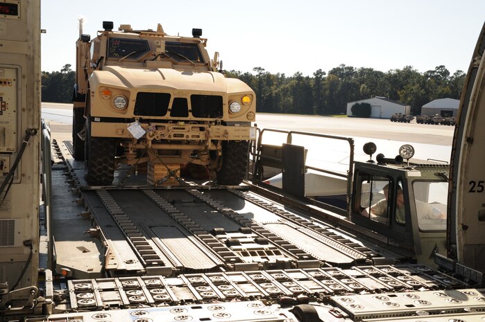 A mine-resistant, ambush-protected all-terrain vehicle is loaded from a Tunner 60K Loader onto a Boeing 747-400 aircraft here Nov. 7. Air transportation specialists with the 437th Aerial Port Squadron fit five M-ATVs on the civilian aircraft during the first-ever load aboard a 747-400. (U.S. Air Force photo/Staff Sgt. Marie Brown)