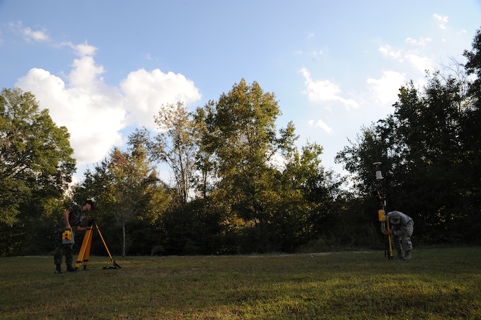 Airmen 1st Class Nicole Reynolds and Michael Payne disassemble equipment used during a site survey here Nov. 4. Surveys can be used to define a specific location's existence in physical space through the use of satellites which determine the placement of water lines for construction or safety purposes. Airmen Reynolds and Payne are engineering assistants with the 437th Civil Engineer Squadron Site Development Shop. (U.S. Air Force photo/Senior Airman Katie Gieratz)