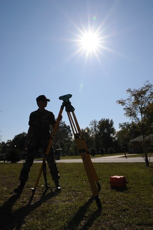 Airman 1st Class Nicole Reynolds sets up an Auto-Level measurement tool in Hunley Park family housing here for training on performing site surveys Nov. 4. The Auto-Level is used to gather and transfer elevation levels to ensure a foundation is level during site surveys or building construction. Airman Reynolds is an engineering assistant with the 437th Civil Engineer Squadron Site Development Shop. (U.S. Air Force photo/Senior Airman Katie Gieratz)