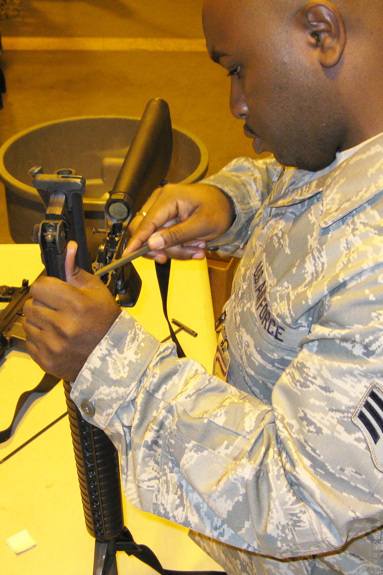 GRISSOM AIR RESERVE BASE, Ind., --  Senior Airman James Scott, a customer service apprentice with the 434th Mission Support Flight, works to clean an M16 during a special detail held on the November unit training assembly. Airmen from Grissom cleaned weapons used during a recent exercise before storing them away. (U.S. Air Force photo/SrA. Carl Berry)